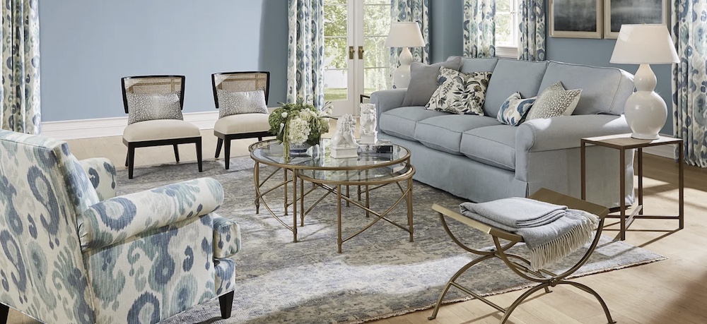 A skillful mix of seating and surfaces come together to create a welcoming space. Flexible pieces include a nesting coffee table and a metal bench. 

Ballard Designs