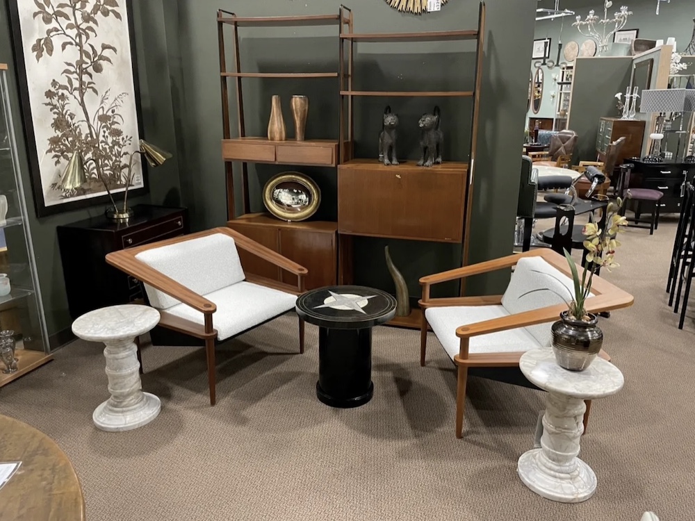 These mid-century teak armchairs are larger in scale than the vintage marble side tables and the compass rose stone and brass table in the center, but this collection works because the chairs were positioned close together and the tables were arranged as a group.

Scott Sprague Photography/Judy Frankel Antiques