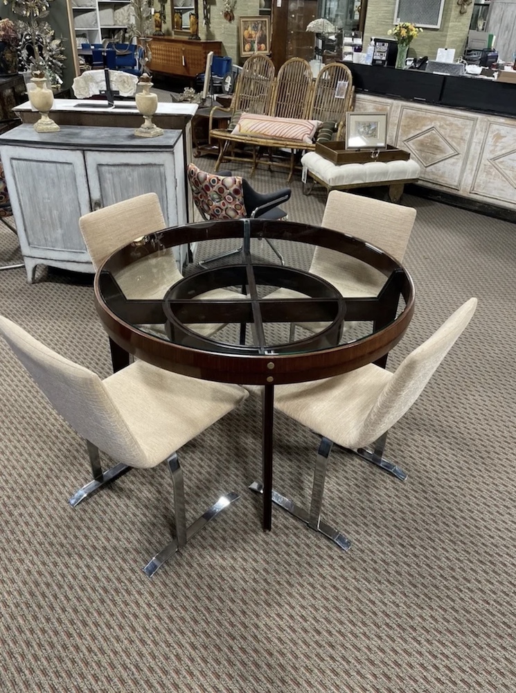The contrast in color and style between this small Italian mahogany and glass table and the very sleek Italian steel-based dining chairs makes a great combination.

Judy Frankel Antiques